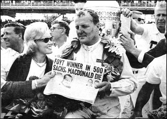 1964 Indy 500 winner AJ Foyt holds newspaper about Dave MacDonald and Eddie Sachs death